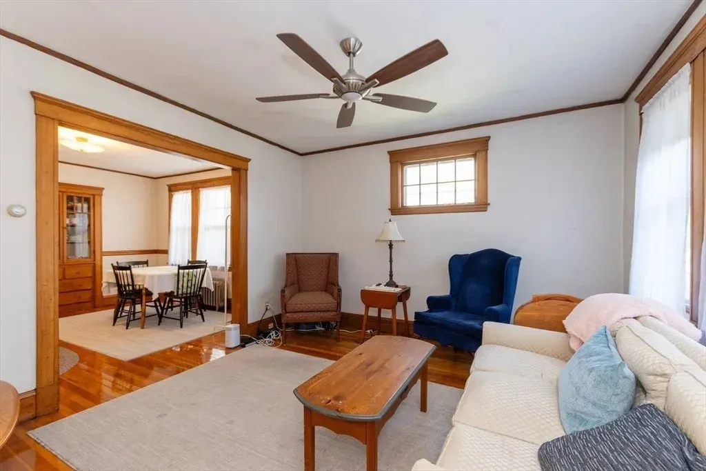 Living room before the design transformation, with mismatched seating and an undefined layout