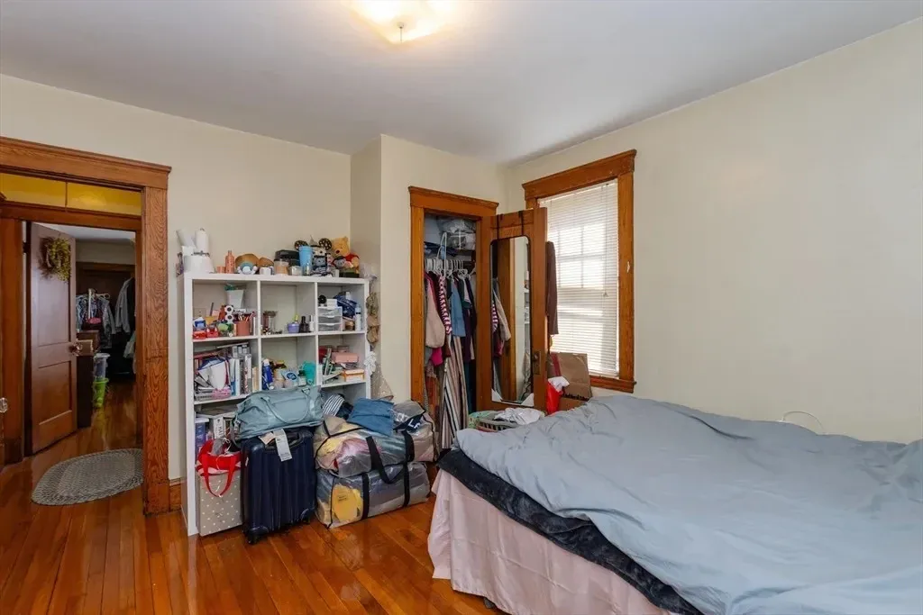 Primary bedroom before the design transformation, with an unstructured furniture layout